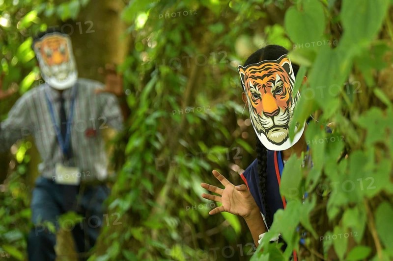 Agartala, Tripura, India, 29-07-2025: Students of NSS (National Service Scheme) unit from Mahatma Gandhi Memorial School wearing tiger masks during an event on Tiger Conservation on International Tiger day, organised by Sima Chakma, coordinator of MGM NSS UNIT at Agartala. International Tiger day is an annual celebration to raise awareness for tiger conservation, held annually on 29th July. Photo By-Abhisek Saha