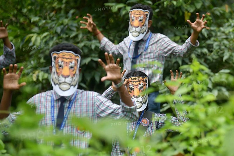 Agartala, Tripura, India, 29-07-2025: Students of NSS (National Service Scheme) unit from Mahatma Gandhi Memorial School wearing tiger masks during an event on Tiger Conservation on International Tiger day, organised by Sima Chakma, coordinator of MGM NSS UNIT at Agartala. International Tiger day is an annual celebration to raise awareness for tiger conservation, held annually on 29th July. Photo By-Abhisek Saha