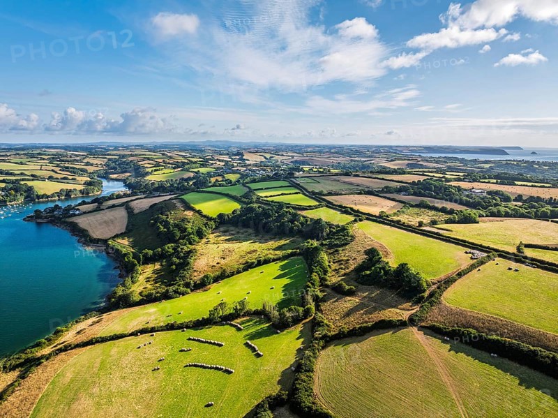 Farms and Fields over St Mawes from drone, Carrick Roads, River Fal, Falmouth, Cornwall, UK