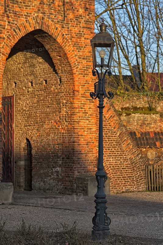 Classic lantern in front of historic brick building (Linn Castle gate) in the light show, Krefeld