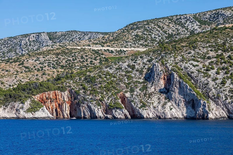 View from the sea to the red rocks, island of Hvar, Dalmatia, Croatia