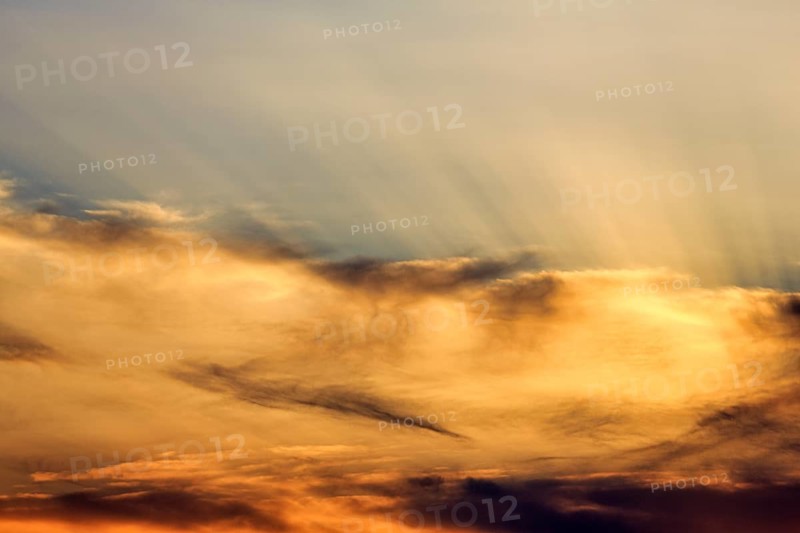 Sunset behind cloud cover, sunbeams, Oia, Thira, Santorini, Cyclades, Greece