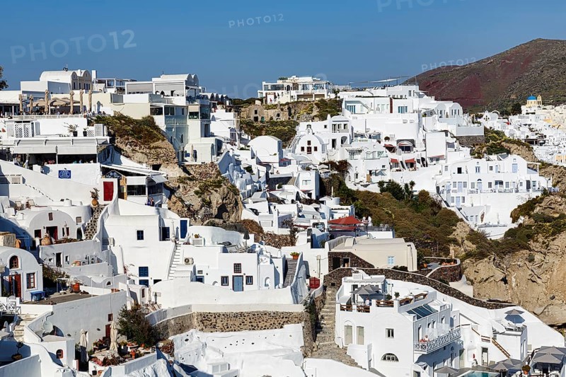 Typical white architecture on a hillside, cave dwellings, holiday flats, stairs, narrow alleyways, Oia, Thira, Santorini, Cyclades, Greece