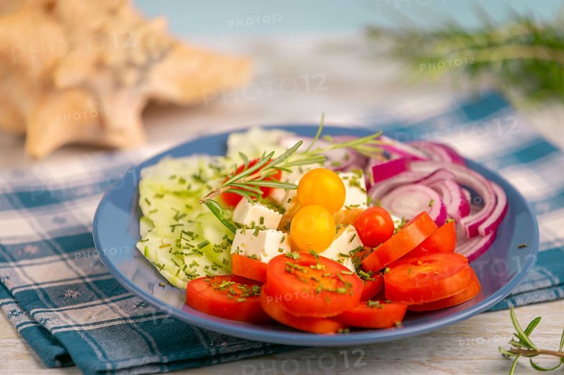 Plate with vegetables and feta in a maritime atmosphere