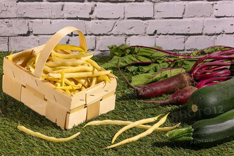 Vegetable mix of yellow beans, beetroot and courgettes on green grass