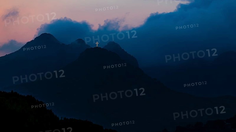 Illuminated steel cross on the summit of Monte Mar di Capanna, above Porto Azzurro, night shot, Elba Island, Tuscan Archipelago National Park, Tuscany, Italy