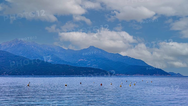 Clouds over the Golfo di Viticcio, in the background the mountains of Monte Capanne, Elba Island, Tuscan Archipelago National Park, Tuscany, Italy