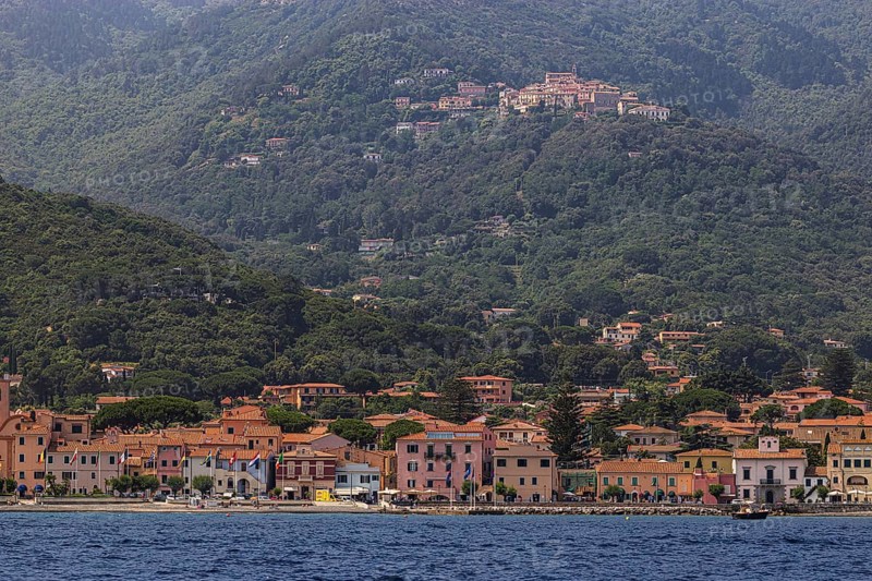 The harbour of Marziana Marina, behind the mountain village of Poggio, Elba Island, Tuscan Archipelago National Park, Tuscany, Italy