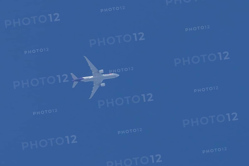 Airbus A300-600RF jet aircraft of FedEx Express airlines in flight in a blue sky, England, United Kingdom