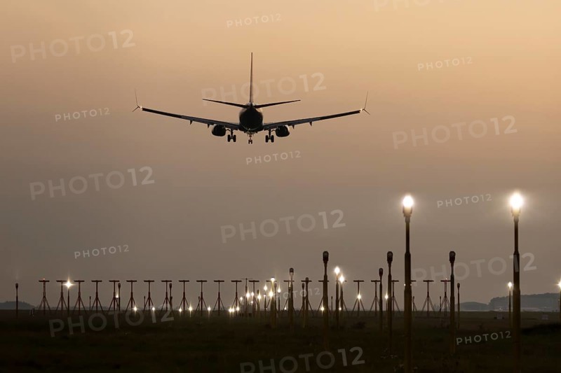 Boeing 737 jet passenger aircraft of Ryanair airlines in flight landing at sunset at London Stansted airport, Essex, England, United Kingdom