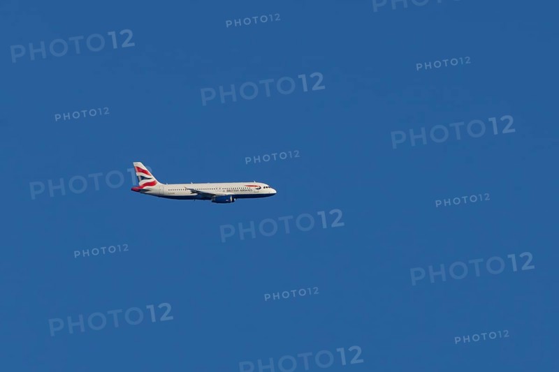 Airbus A320-232 jet passenger aircraft of British Airways airlines in flight in a blue sky, London, England, United Kingdom
