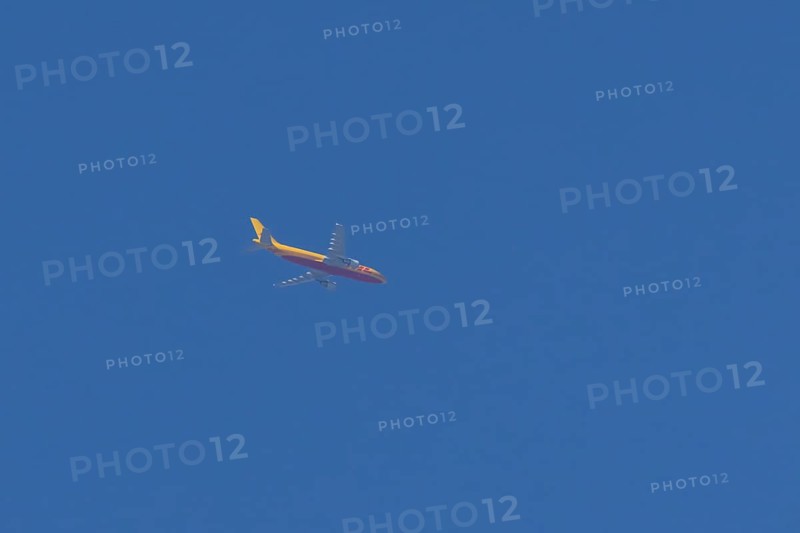 Boeing 767 jet aircraft of DHL cargo airlines in flight in a blue sky, England, United Kingdom