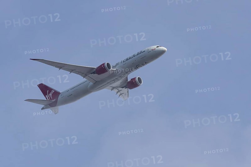 Boeing 787-9 Dreamliner jet passenger aircraft of Virgin Atlantic airlines in flight in a blue sky, England, United Kingdom