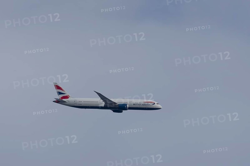 Boeing 787-9 Dreamliner jet passenger aircraft of British Airways airlines in flight in a blue sky, London, England, United Kingdom