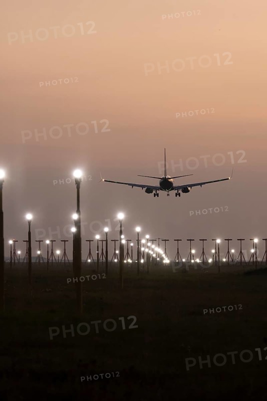Boeing 737 jet aircraft of Ryanair airlines in flight landing at sunset at London Stansted airport, Essex, England, United Kingdom