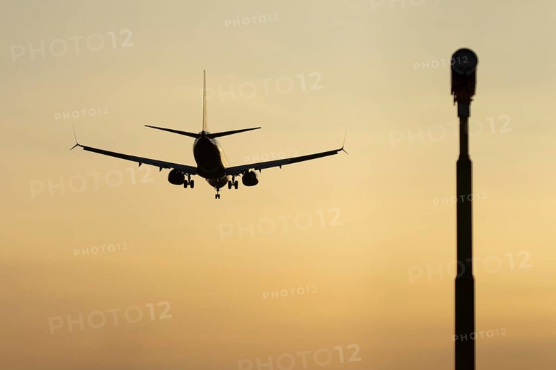 Boeing 737 jet passenger aircraft of Ryanair airlines in flight landing at sunset at London Stansted airport, Essex, England, United Kingdom