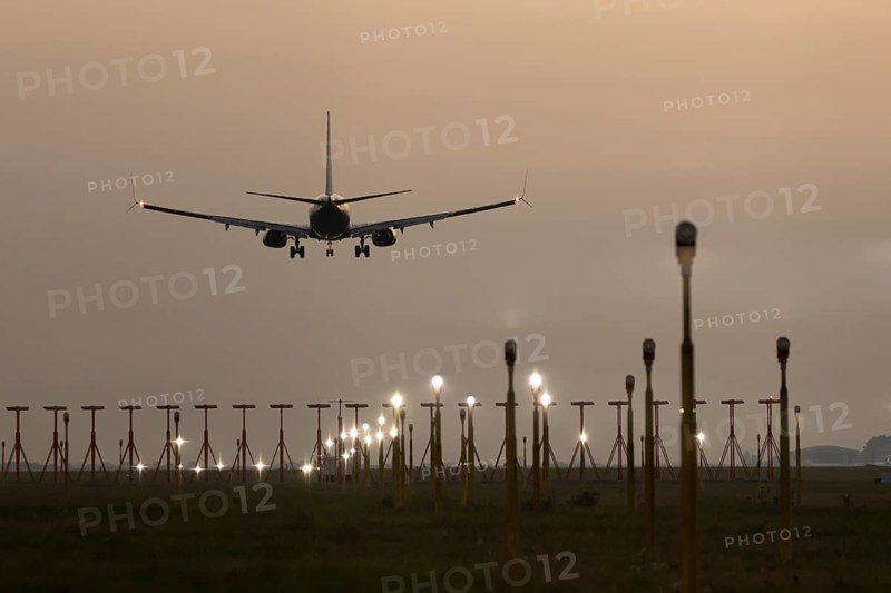 Boeing 737 jet passenger aircraft of Ryanair airlines in flight landing at sunset at London Stansted airport, Essex, England, United Kingdom