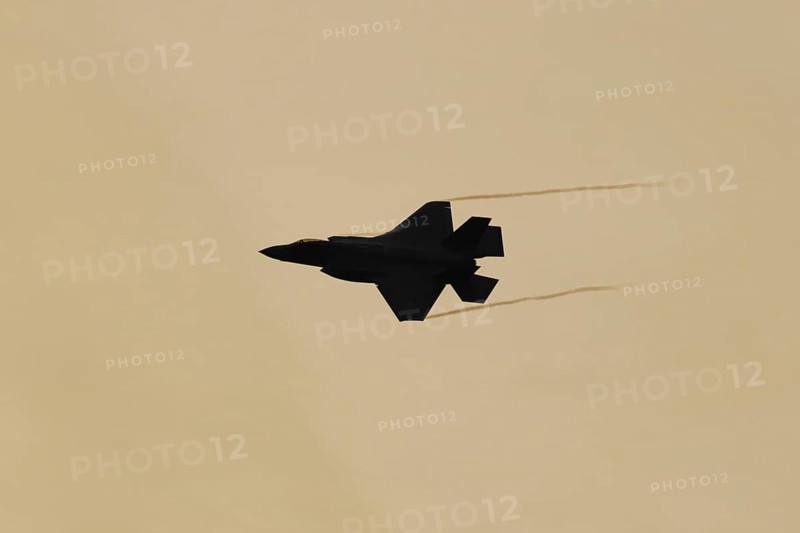 Lockheed Martin F-35 Lightning II fighter military aircraft of the United States air force USAF silhouette in flight at sunset at RAF Lakenheath airbase, Suffolk, England, United Kingdom