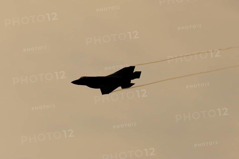 Lockheed Martin F-35 Lightning II fighter military aircraft of the United States air force USAF silhouette in flight at sunset at RAF Lakenheath airbase, Suffolk, England, United Kingdom