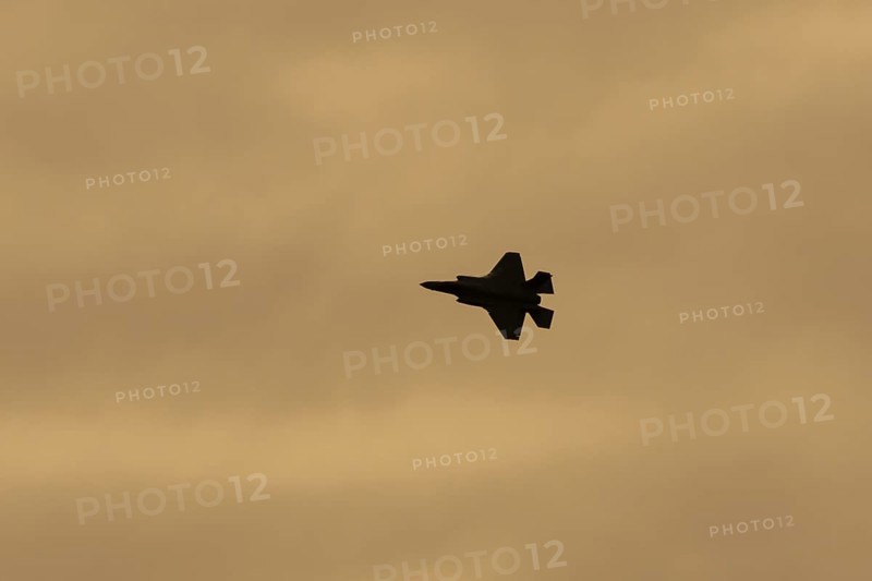 Lockheed Martin F-35 Lightning II fighter military aircraft of the United States air force USAF silhouette in flight at sunset at RAF Lakenheath airbase, Suffolk, England, United Kingdom