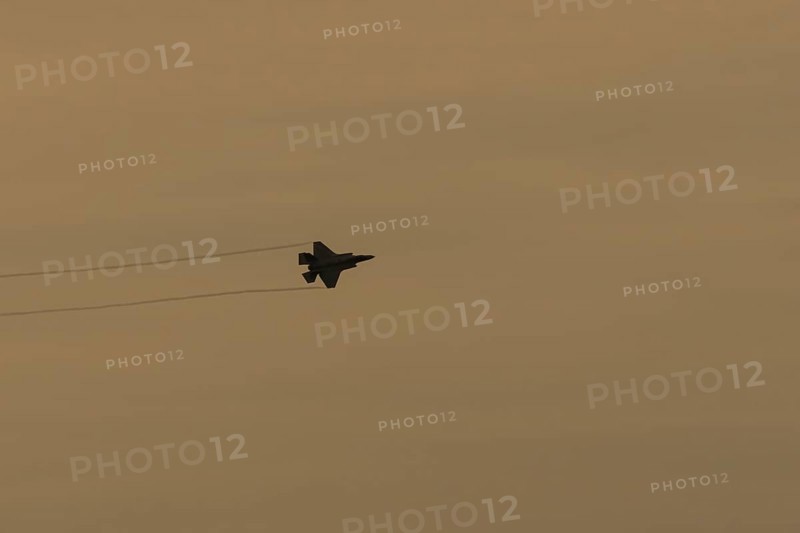 Lockheed Martin F-35 Lightning II fighter military aircraft of the United States air force USAF silhouette in flight at sunset at RAF Lakenheath airbase, Suffolk, England, United Kingdom