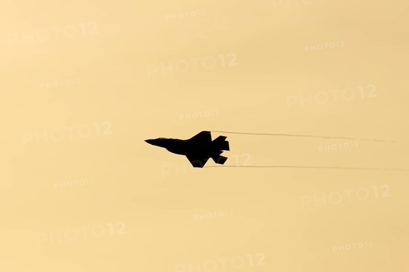 Lockheed Martin F-35 Lightning II fighter military aircraft of the United States air force USAF silhouette in flight at sunset at RAF Lakenheath airbase, Suffolk, England, United Kingdom