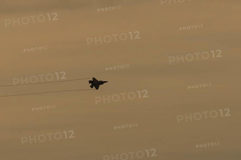 Lockheed Martin F-35 Lightning II fighter military aircraft of the United States air force USAF silhouette in flight at sunset at RAF Lakenheath airbase, Suffolk, England, United Kingdom