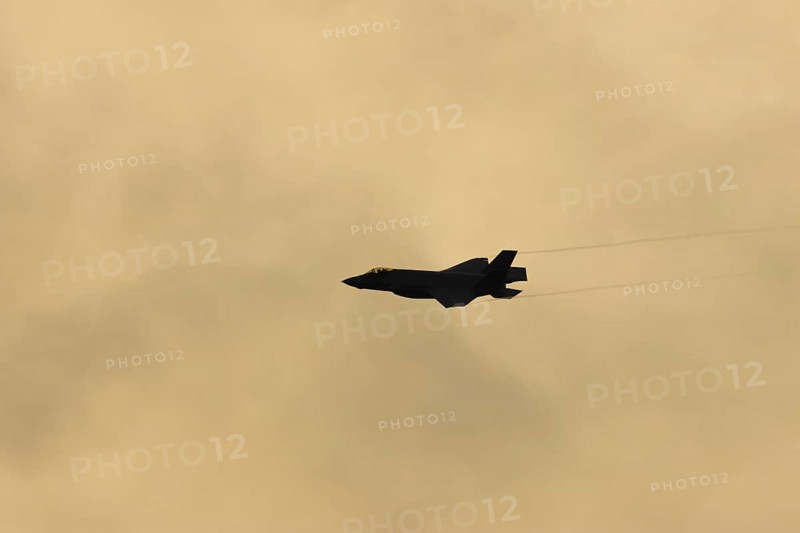 Lockheed Martin F-35 Lightning II fighter military aircraft of the United States air force USAF silhouette in flight at sunset at RAF Lakenheath airbase, Suffolk, England, United Kingdom