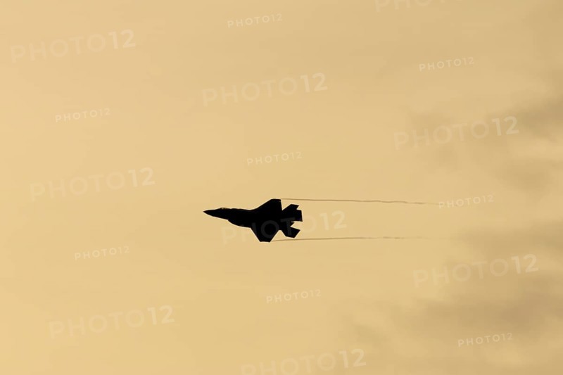Lockheed Martin F-35 Lightning II fighter military aircraft of the United States air force USAF silhouette in flight at sunset at RAF Lakenheath airbase, Suffolk, England, United Kingdom