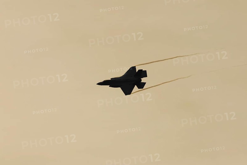 Lockheed Martin F-35 Lightning II fighter military aircraft of the United States air force USAF silhouette in flight at sunset at RAF Lakenheath airbase, Suffolk, England, United Kingdom