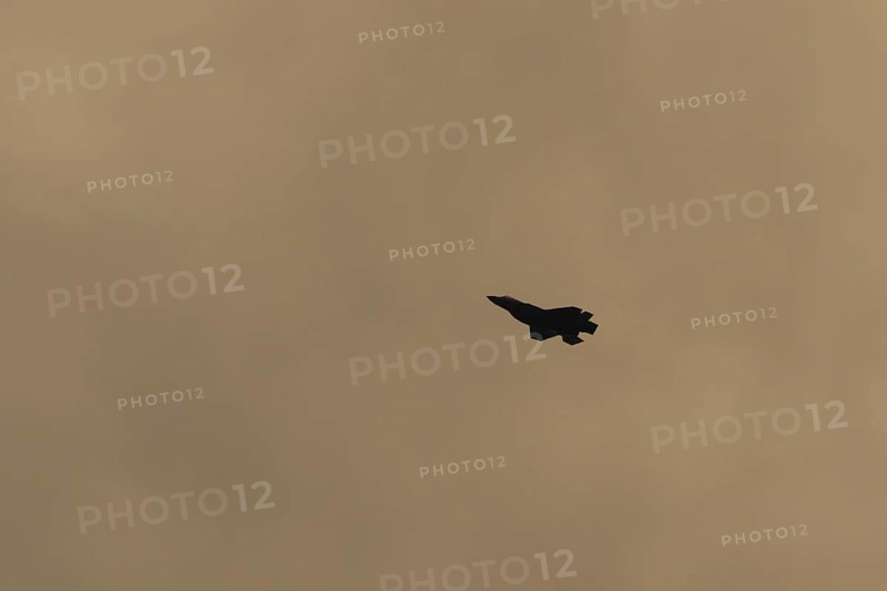 Lockheed Martin F-35 Lightning II fighter military aircraft of the United States air force USAF silhouette in flight at sunset at RAF Lakenheath airbase, Suffolk, England, United Kingdom