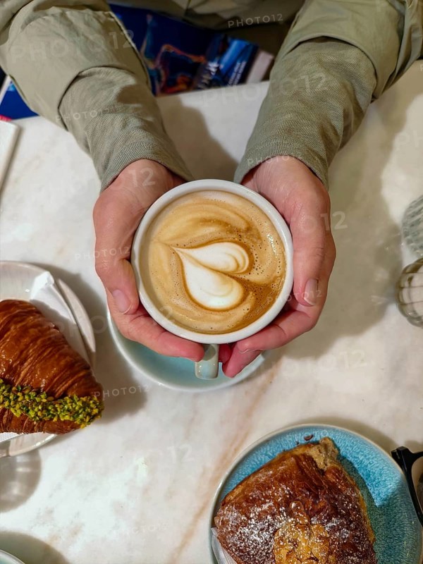 Cappuccino with heart-shaped latte and croissants served on a breakfast table Lower Austria Austria