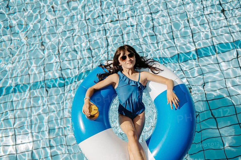 Girl, 10, swims in a swimming tyre in the pool