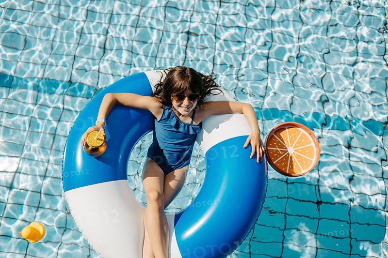 Girl, 10, swims in a swimming tyre in the pool