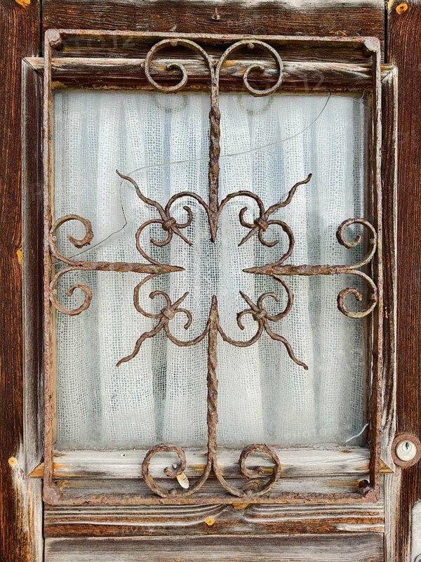 Old, rusty window grille in a weathered wooden frame Lower Austria Austria