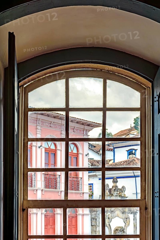 View of the city of Ouro Preto through an old window in a colonial mansion, Ouro Preto, Minas Gerais, Brazil