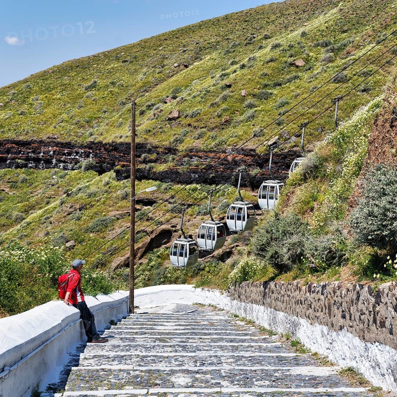 Hiker on stairs, old road to the harbour of the capital Fira, cable car, Thira, Santorini, Cyclades, Greece
