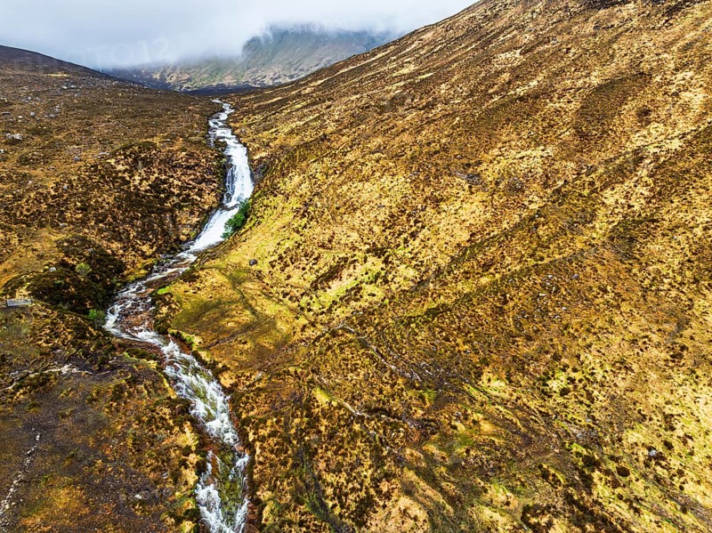 Eas a' Bhradain Waterfall from drone, Red Cuillin mountains, Loch Ainort, Isle of Skye, Scotland, UK