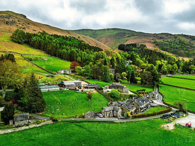 Farms and Mountains over road A591 from a drone, Grasmere Lake, Grasmere, Ambleside, Lake District, Westmorland, Cumbria, UK