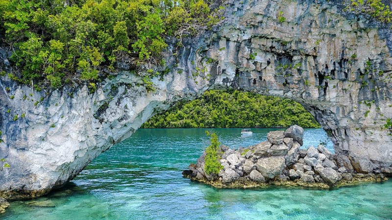 View through rock arch Natural Arch in lagoon of in island paradise island state Palau in the Pacific West Pacific, Rock Islands, Republic of Palau, Micronesia, Australia, Oceania