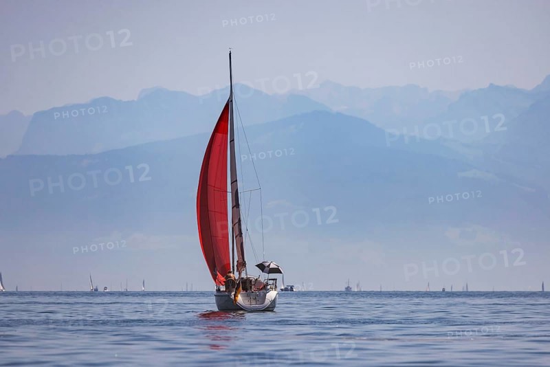 Sailing ship travelling on Lake Constance. The Swiss Alps in the background. Immenstaad, Baden-Württemberg, Germany