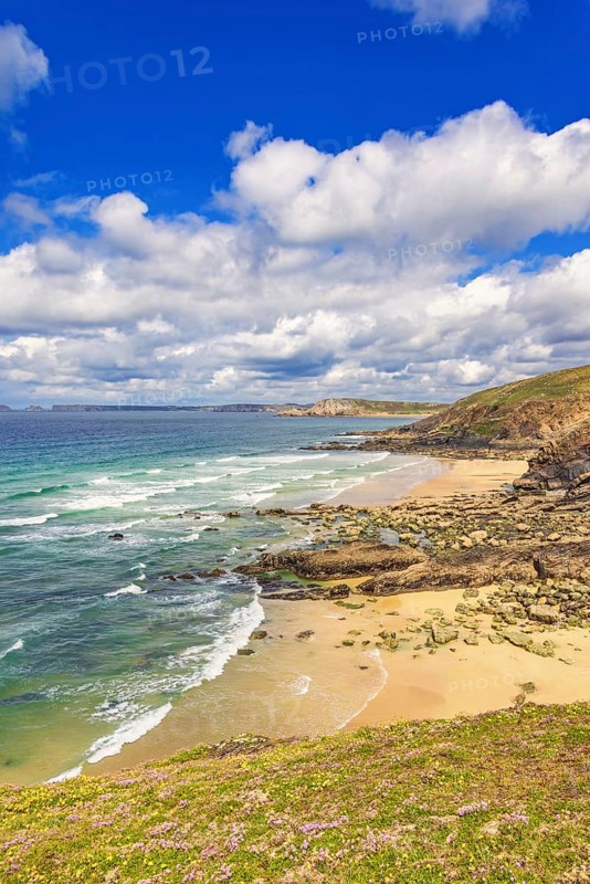 Rolling waves to the beach at a rocky coastline a beautiful sunny day by the sea, Crozon peninsula, Bretagne, France