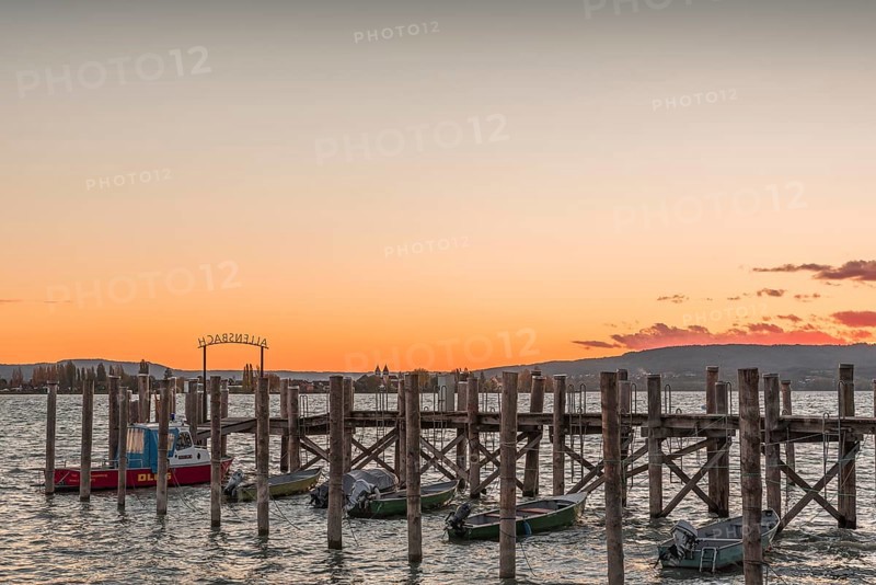 Sunset over a wooden footbridge in Allensbach, Lake Constance, Baden-Württemberg, Germany