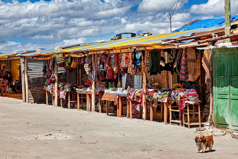 Colourful market stalls along a road under a cloudy sky, lively rural scene, market stall for tourists in the Salar de Uyuni in Bolivia