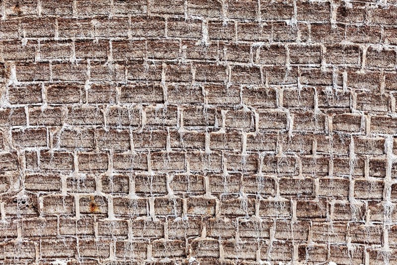General view of a textured brick wall in earthy tones with an antique look, A wall made of salt bricks in the Salar de Uyuni in Bolivia