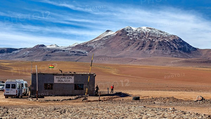 A small migration building in a barren desert landscape with mountains in the background, The small customs station between Chile and Bolivia in the mountains of the Altiplano in Bolivia