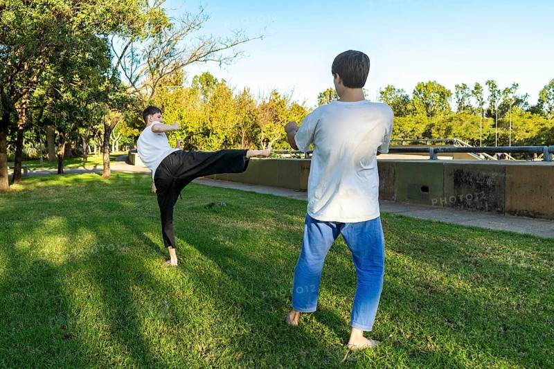 Young martial artists practicing Taekwondo outdoors