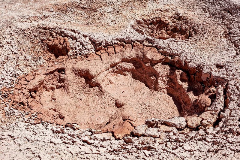 Large geothermal crater with dried mud and cracks, The mud volcanoes and fumaroles on the Altiplano in Bolivia