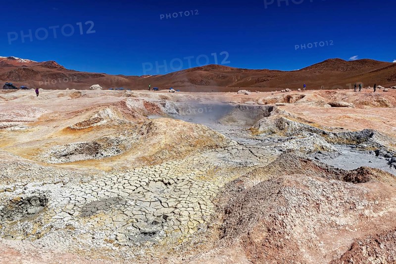 Vast geothermal landscape in a dry desert under a clear sky, The mud volcanoes and fumaroles on the Altiplano in Bolivia