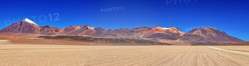 Sweeping panoramic views of a series of mountains, including snow-capped peaks, under a clear sky, The landscape of the Altiplano in Bolivia